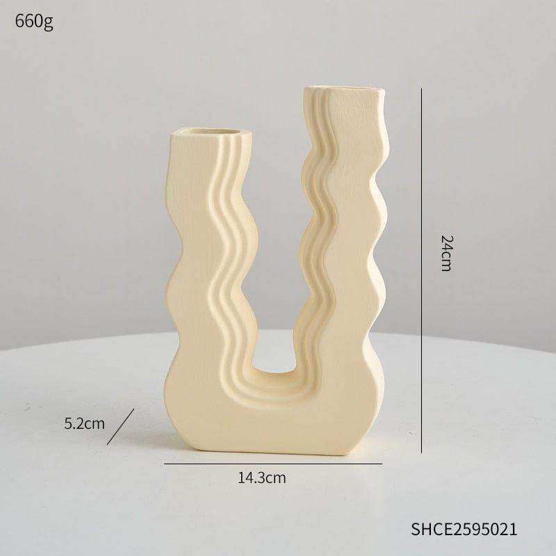 Cream-colored ceramic wavy wonder vase with u-shaped design and two distinct openings for decorative use