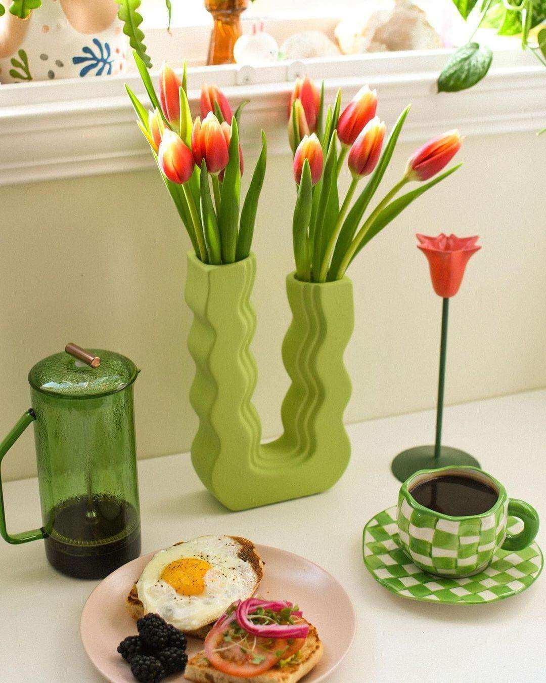 Vibrant red and yellow tulips in a lime green wavy ceramic vase called wavy wonder vase