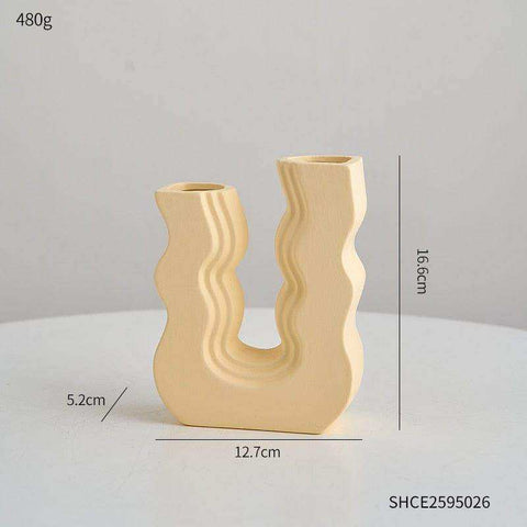 Cream-colored ceramic wavy wonder vase with u-shaped design and two unique openings for decor use