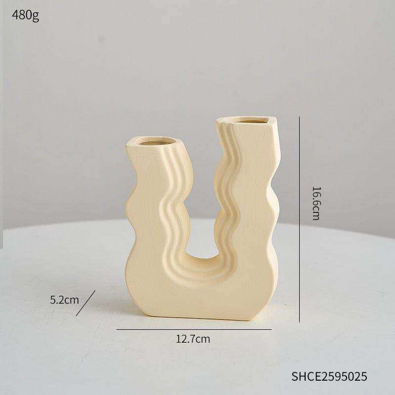 Cream-colored ceramic vase with a modern wavy u-shaped design called wavy wonder vase perfect for home decor