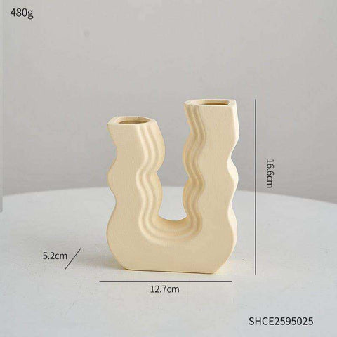 Cream-colored ceramic vase with a modern wavy u-shaped design called wavy wonder vase perfect for home decor