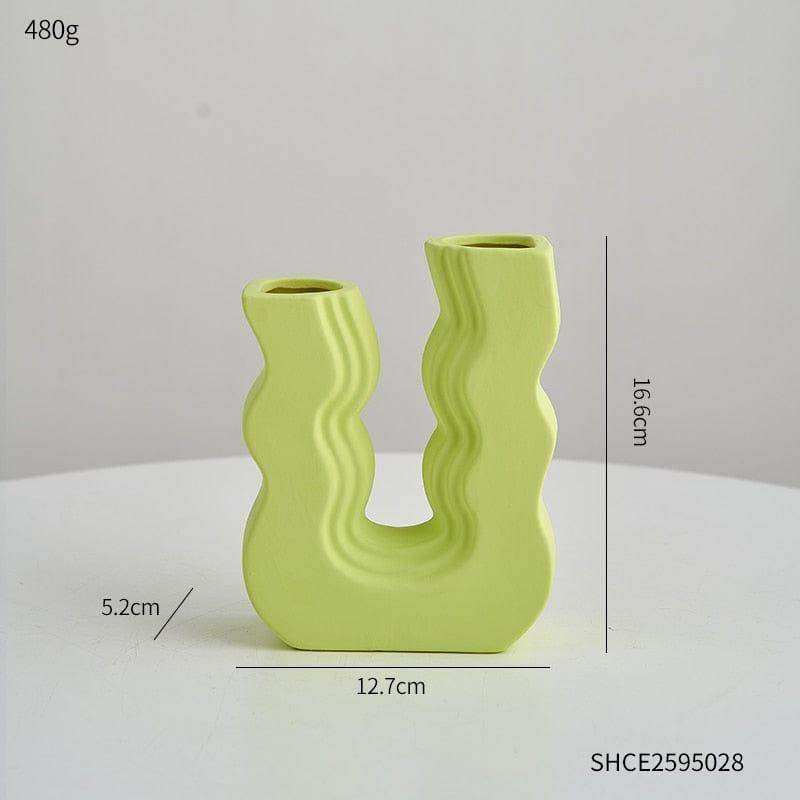 A lime green ceramic wavy wonder vase with u-shaped design and two openings perfect for modern decor