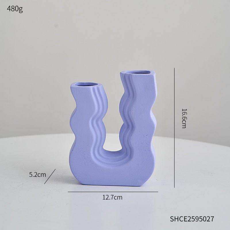 A light purple ceramic wavy wonder vase with a u-shaped design and two curved openings for decoration