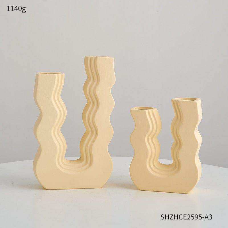 Set of three cream-colored ceramic vases with wavy sculptural designs called wavy wonder vase