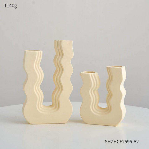 Cream-colored ceramic wavy wonder vase with sculpted abstract modern design perfect for home decor