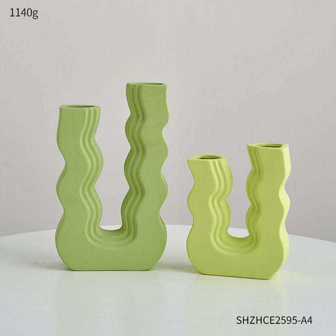 Set of three lime green ceramic vases with wavy sculptural designs called wavy wonder vase