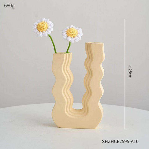 Beige ceramic wavy wonder vase with a sculptural design and two vertical openings for stylish decor