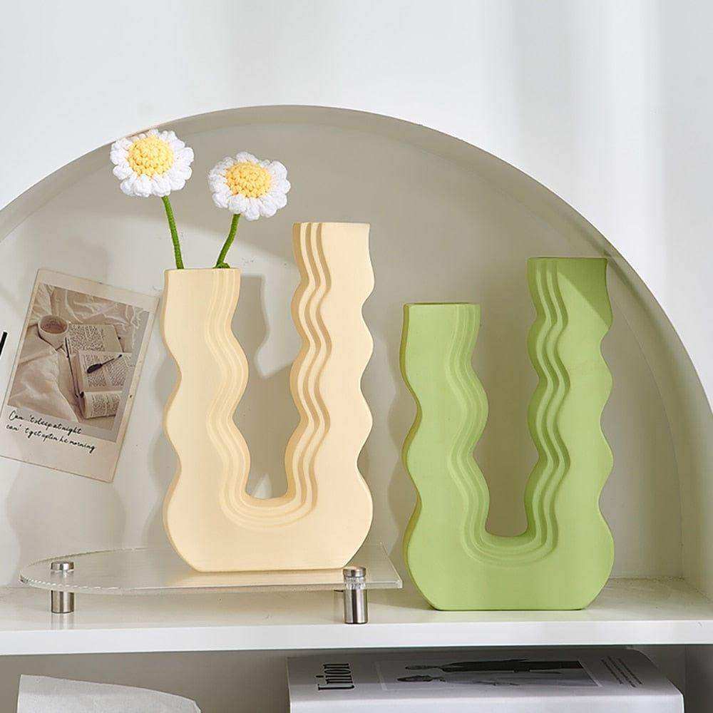 Cream-colored and lime green ceramic wavy wonder vase with u-shaped designs perfect for stylish home decor