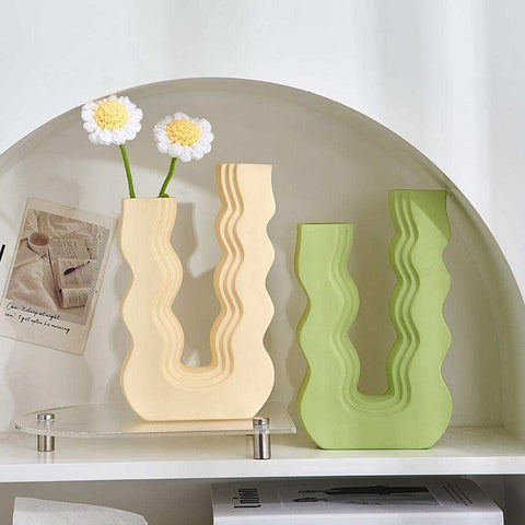 Cream-colored and lime green ceramic wavy wonder vase with u-shaped designs perfect for stylish home decor