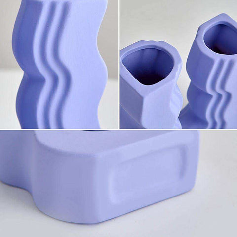 A soft lavender ceramic wavy wonder vase with sculpted wavy body and vertical ridges perfect for decor