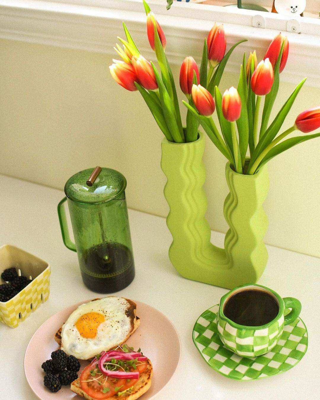 Vibrant red and yellow tulips in sleek lime green wavy wonder vases perfect for bright home decor