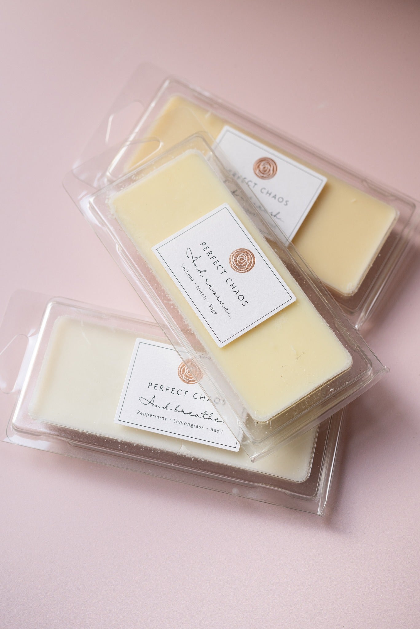 Pale yellow wax melts in clear plastic packaging with perfect chaos label made with essential oils