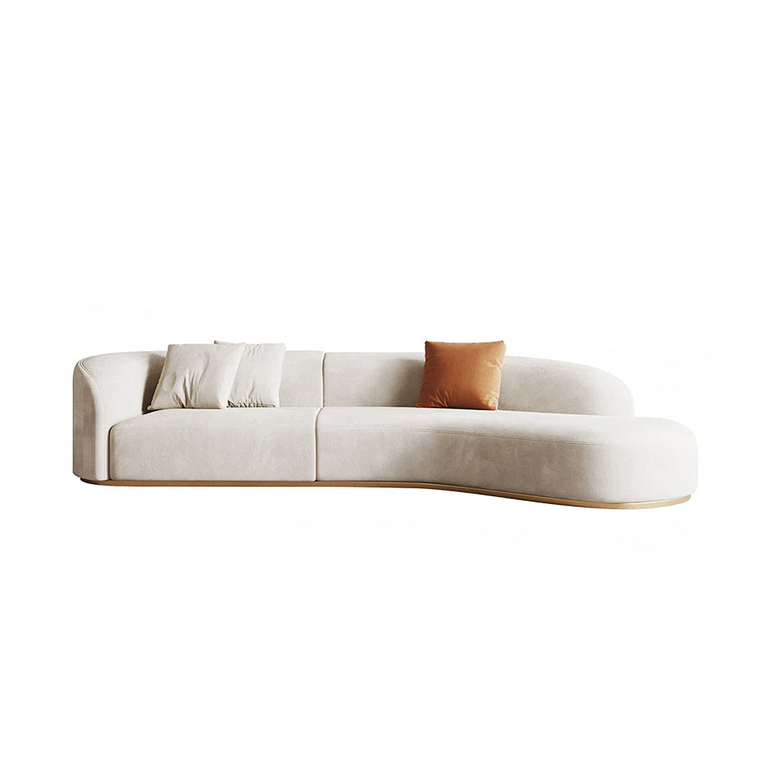 Cream-colored welby three seater velvet curved sofa with soft velvet finish and light wood base for modern living room