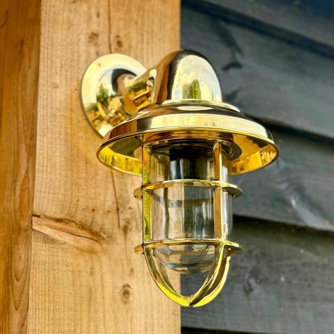 Solid brass wells nautical style wall light with clear glass globe and protective cage for bathroom wall light use