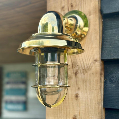 Wells solid brass wall light with nautical clear glass cage and polished finish perfect for bathroom wall light use