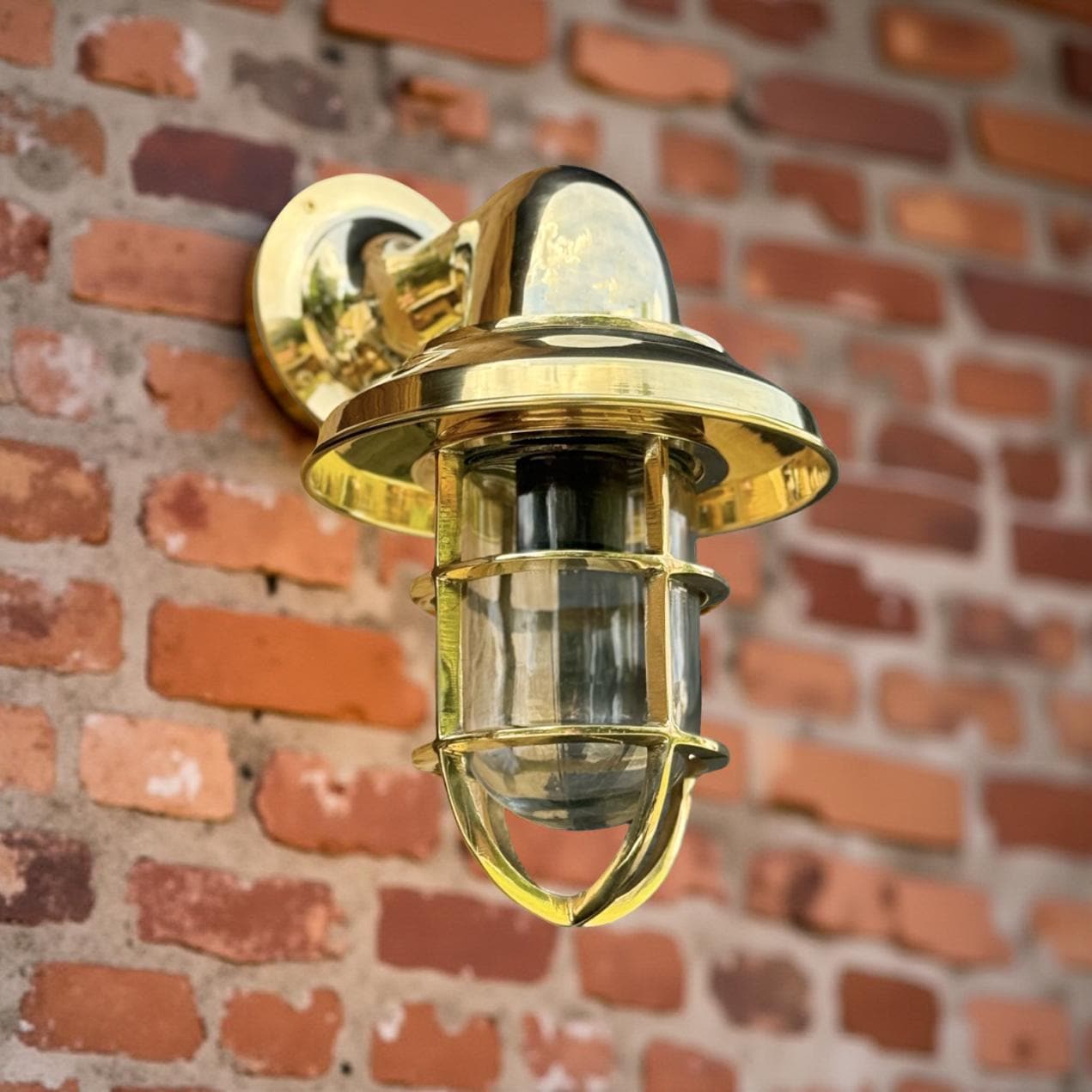 Brass nautical-style solid brass wall light with clear glass and protective cage ideal as bathroom wall light