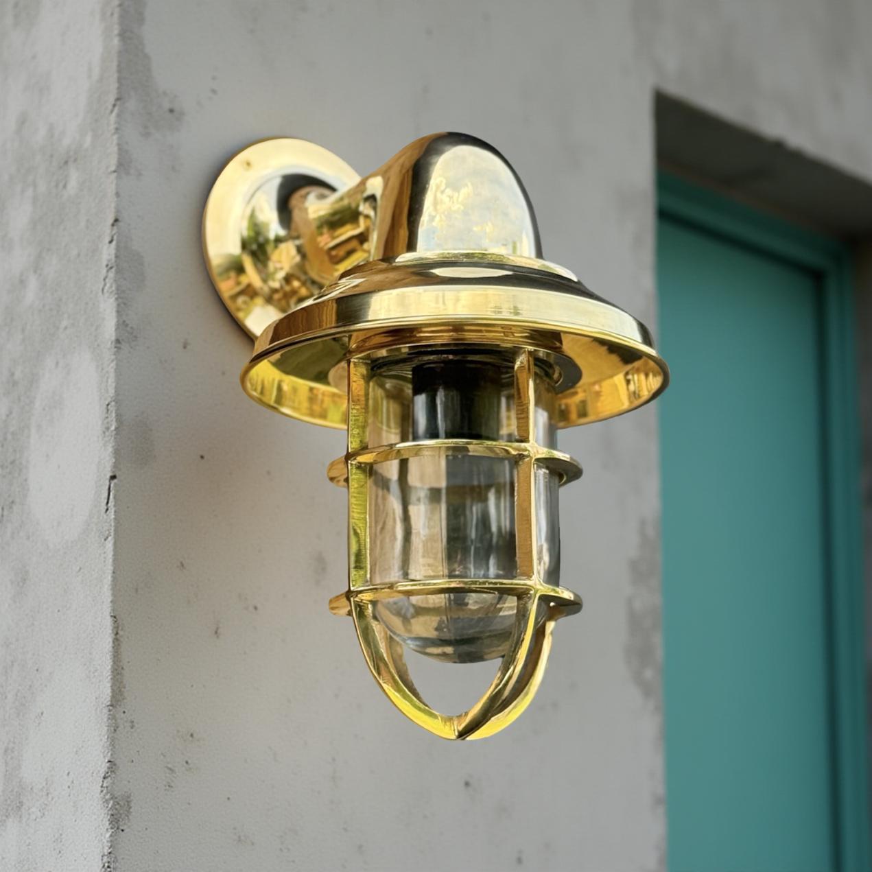 Wells solid brass wall light with clear glass and protective cage perfect for outdoor or bathroom wall light use