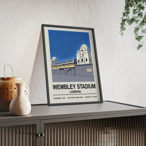 A framed wembley stadium print featuring stylized twin towers with bold blue sky and white architecture