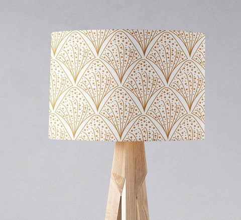 White and gold contemporary table lamp with inch diameter rectangular lampshade on light wood tripod stand