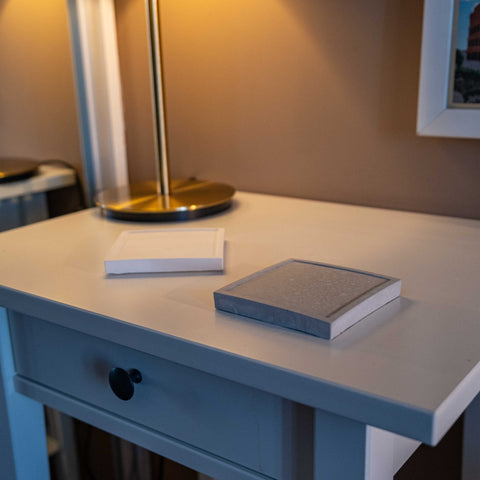 Gray textured white concrete square jewellery holder with white pages on light blue desk drawer great gift idea