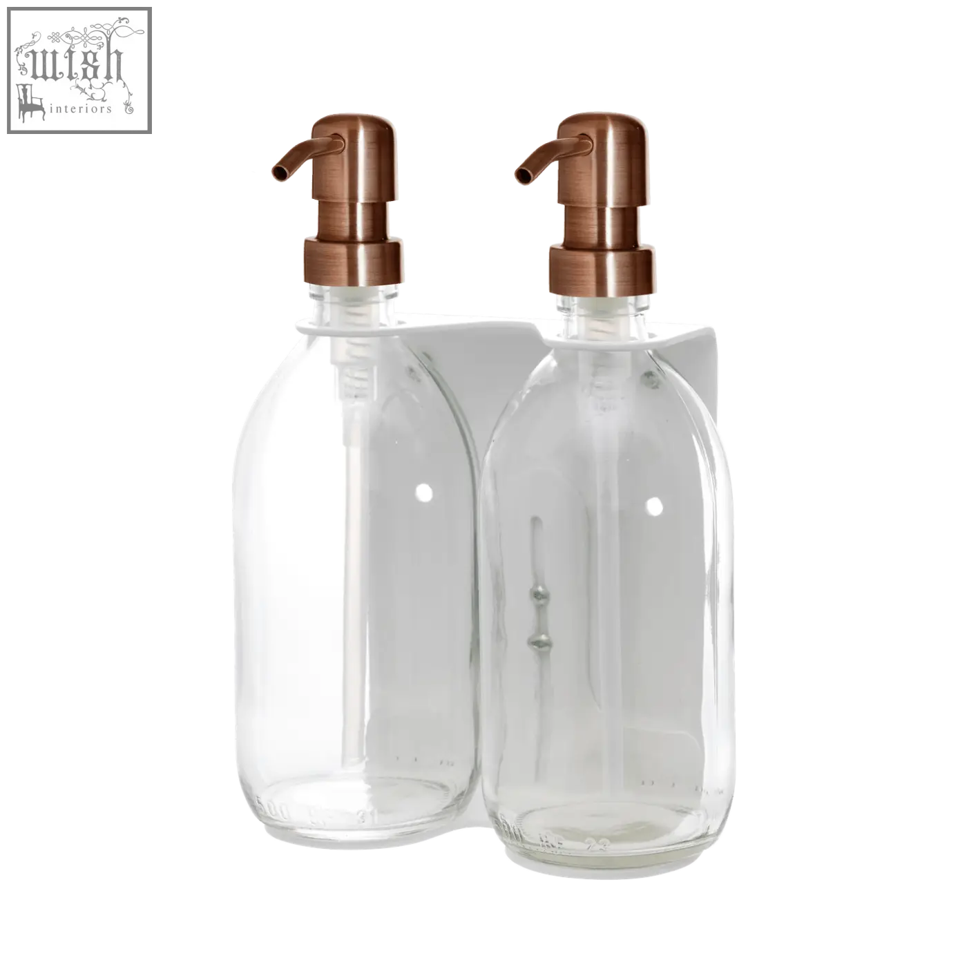 White double wall mounted soap dispenser with clear glass bottles and rose gold pumps on a white wall-mounted bracket