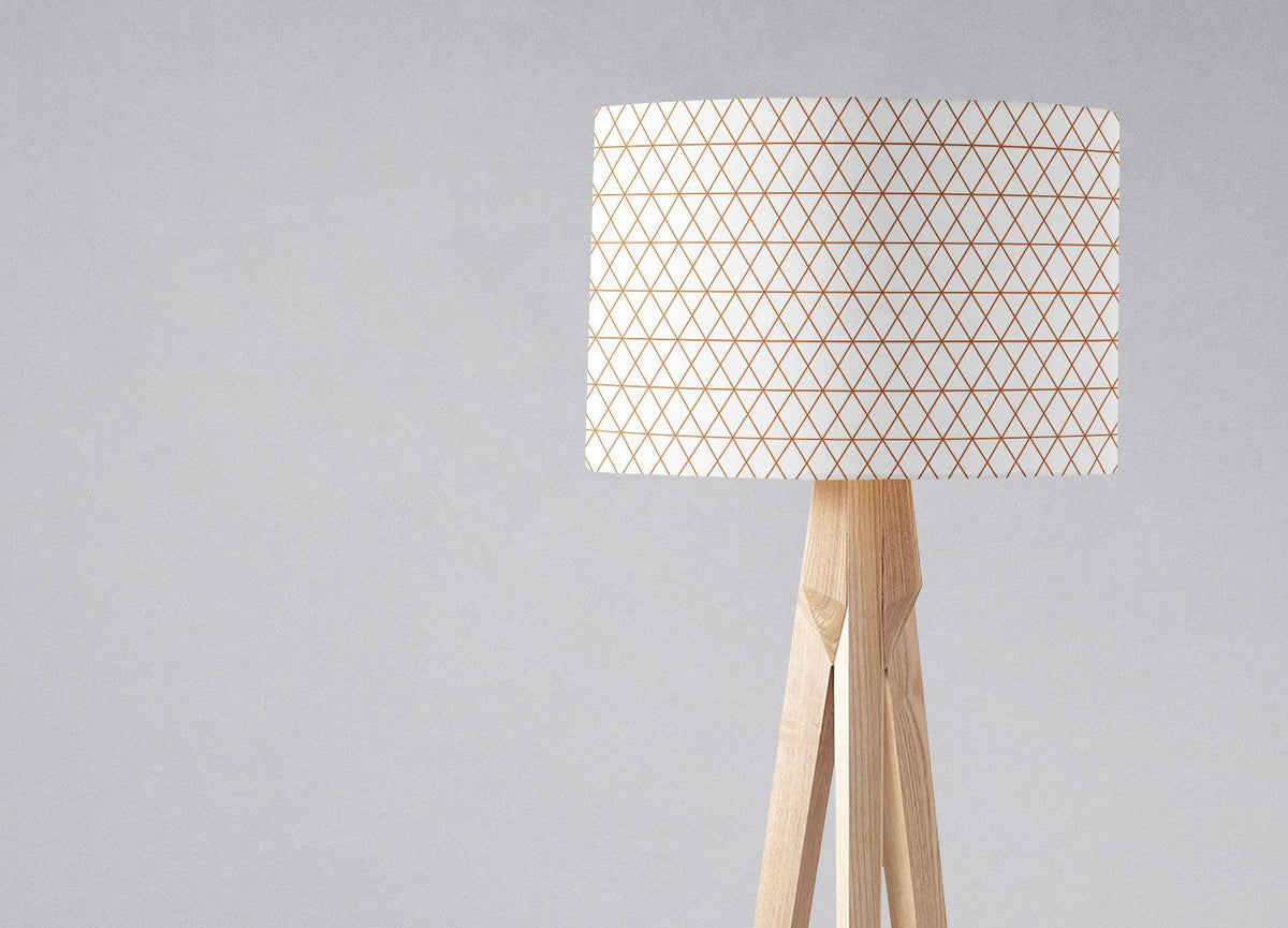 Minimalist tripod floor lamp with white fabric shade featuring copper lines and natural wood base for table lamp use with inch diameter