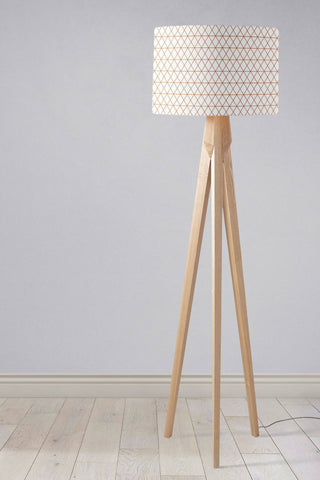 Minimalist tripod floor lamp with light wood finish and beige geometric table lamp shade with inch diameter