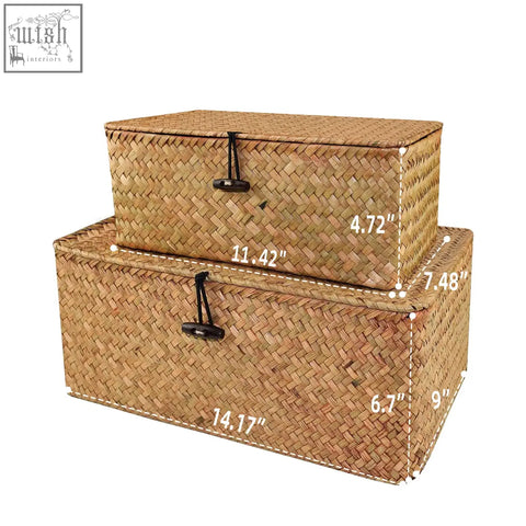 Two woven natural straw seagrass storage baskets with black fabric ties and stitched edges for home organization