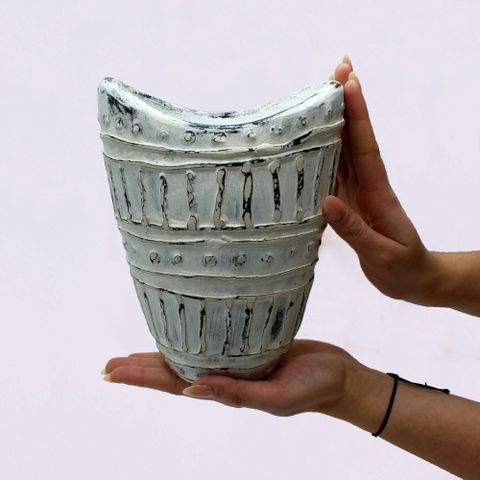 A handcrafted ceramic wide neck shaped vase in cream with distressed glaze and textured dots perfect for dry flowers