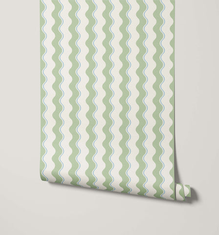 A roll of wiggle wavy stripe wallpaper with soft sage green and pale blue wavy stripes on off-white background