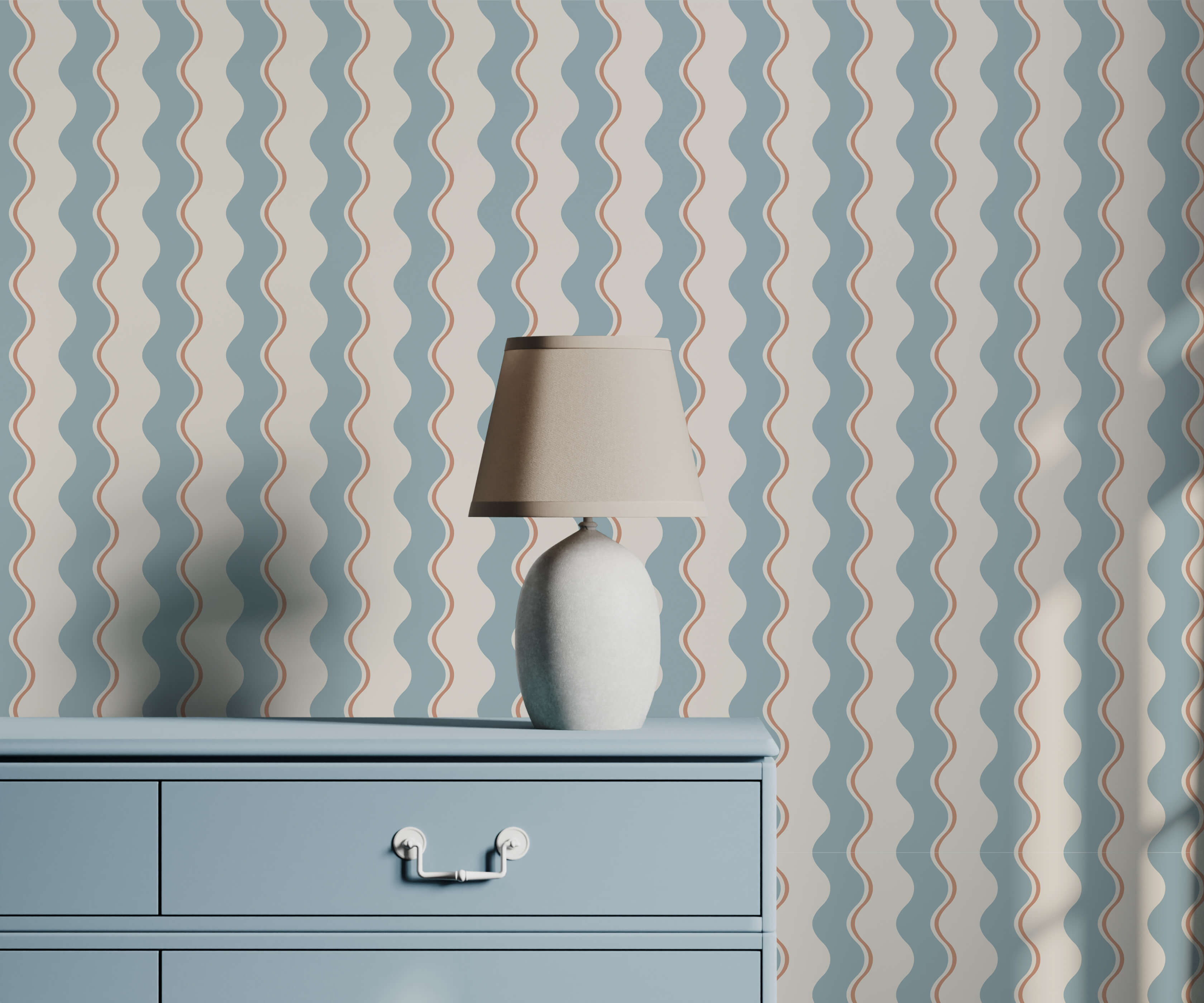 A sleek off-white ceramic wiggle table lamp with a tapered shade on a light blue dresser against wavy stripe wallpaper