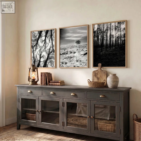 Dark gray rustic sideboard with glass front cabinets and brass handles complements wildlife wall art set of 3 black and white forest photos