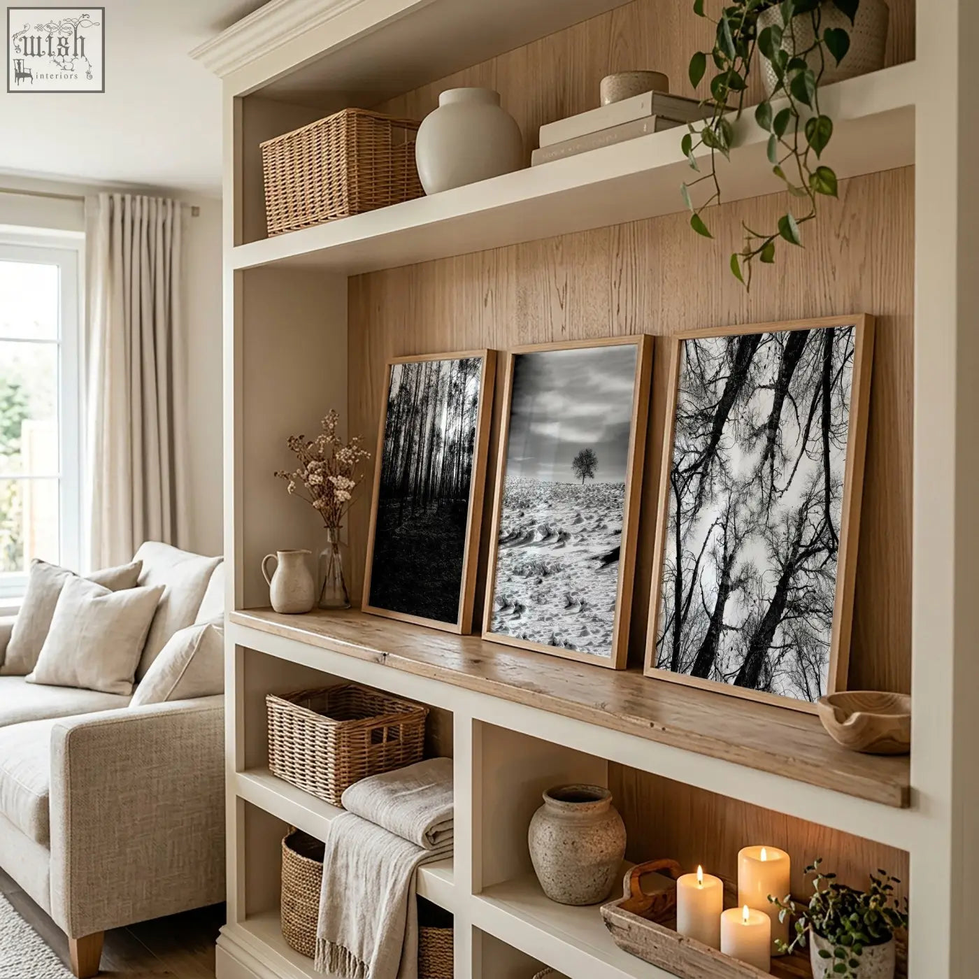 Three framed black and white wildlife wall art photos in light wood frames displayed on a wooden shelf
