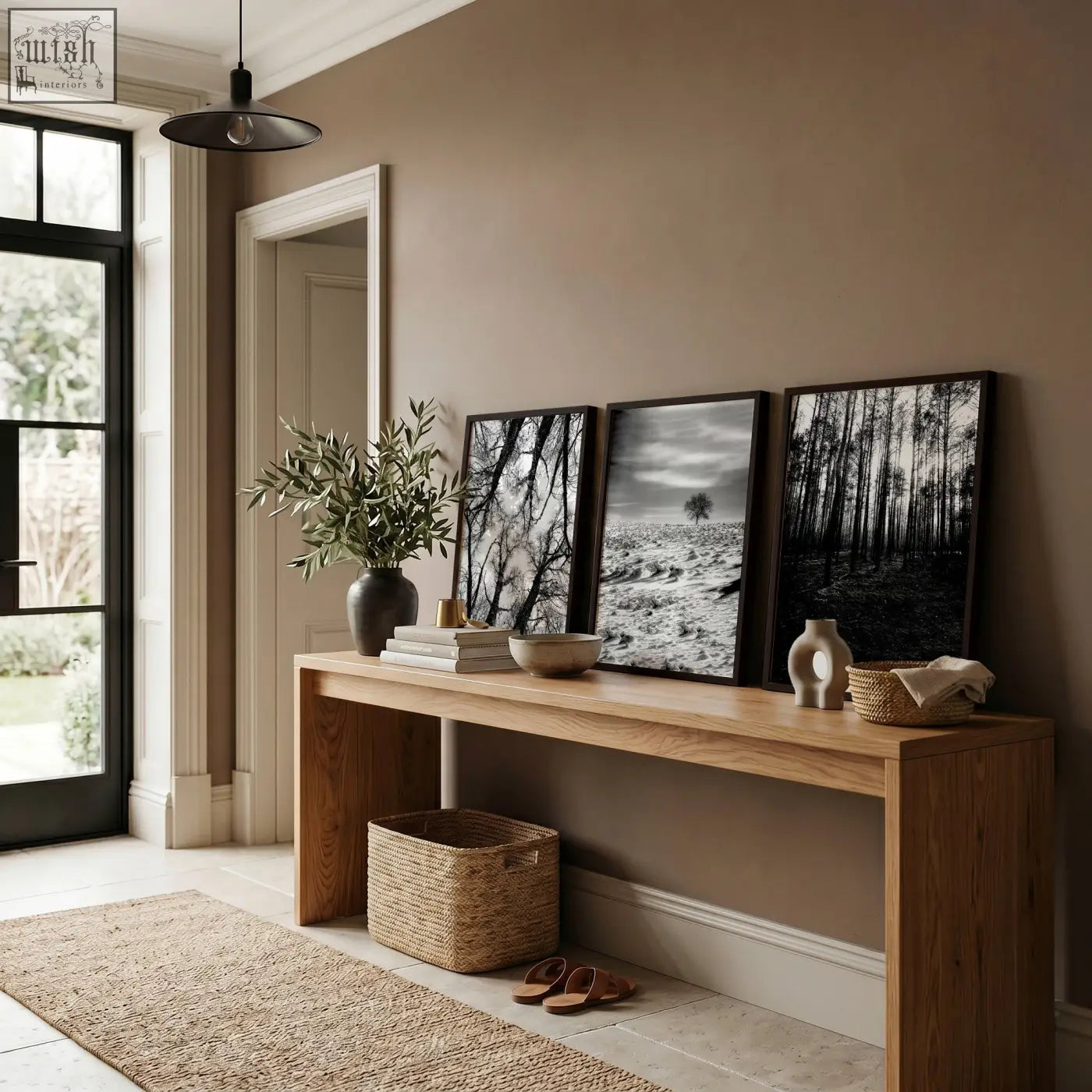 Minimalist wooden console table with natural finish and open shelf below paired with wildlife wall art set of 3