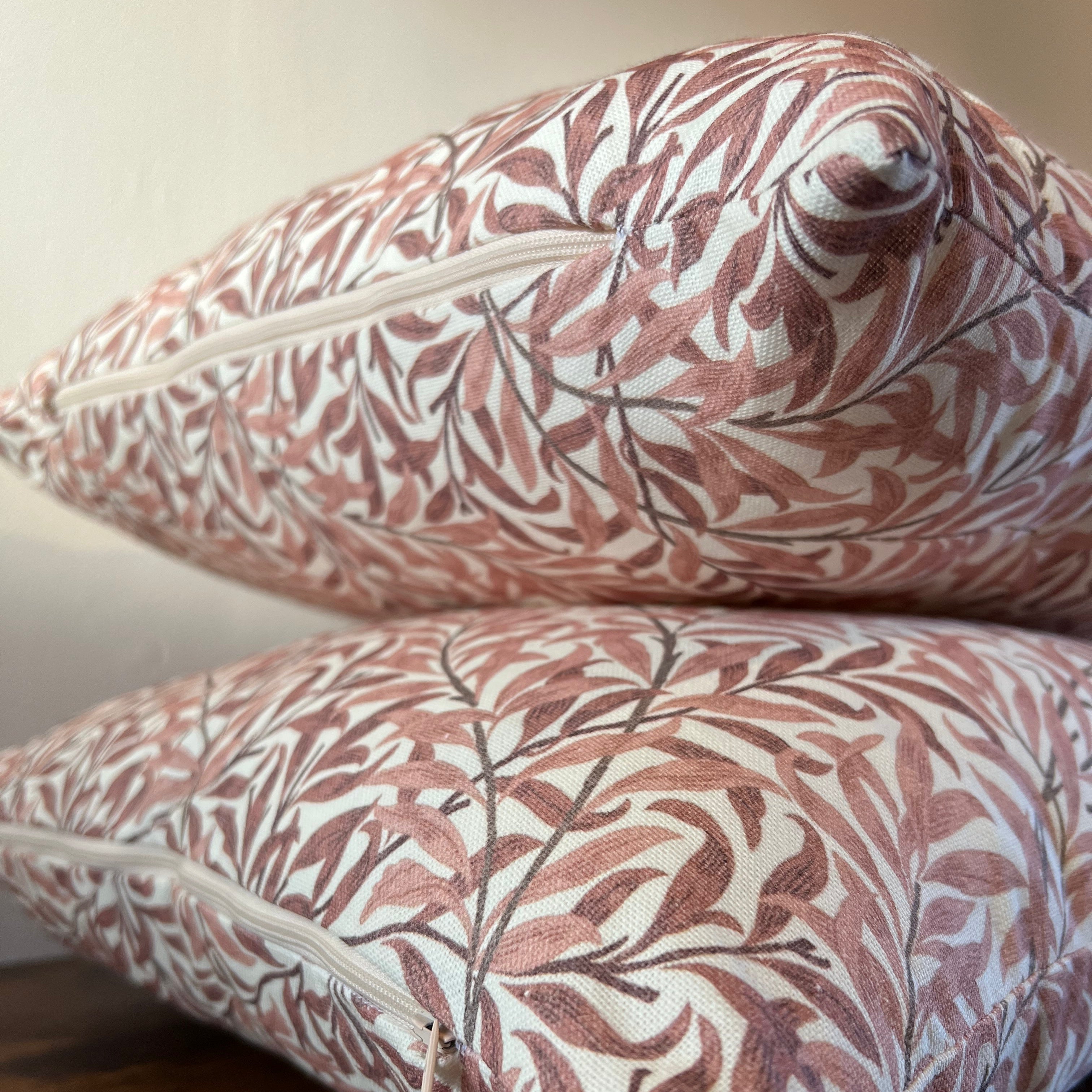 Two william morris rust cotton cushions with woven rust willow leaves pattern in terracotta cream and dark brown outlines