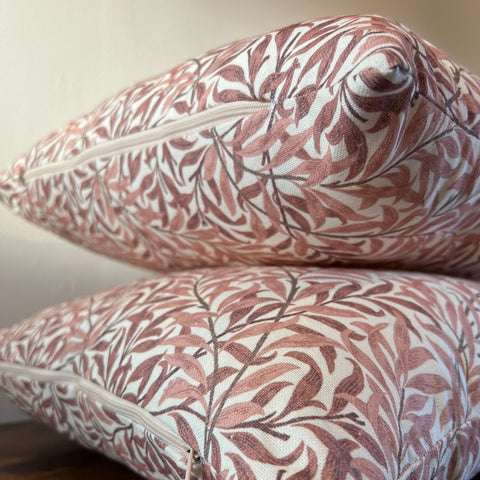 Two william morris rust cotton cushions with woven rust willow leaves pattern in terracotta cream and dark brown outlines
