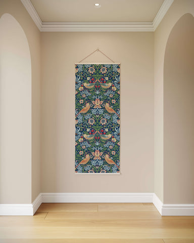 A william morris strawberry thief tapestry with vibrant floral and bird motifs on deep green framed by white borders