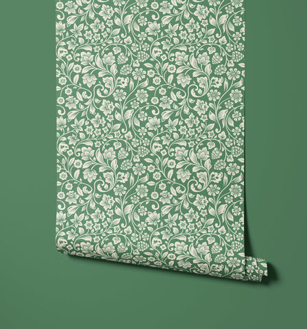 Roll of willow emerald green wallpaper with intricate white floral and vine patterns for stylish walls