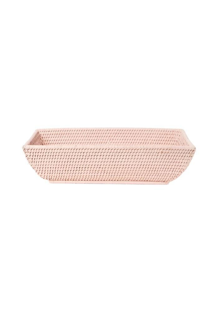 A rectangular blush pink woven rattan basket with a textured interlaced pattern called wiltshire long rattan basket in pink