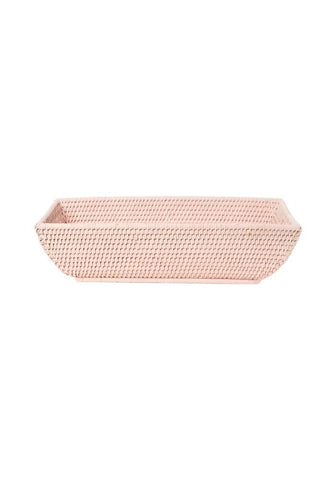 A rectangular blush pink woven rattan basket with a textured interlaced pattern called wiltshire long rattan basket in pink