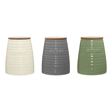 Three ribbed ceramic dolomite sugar canisters with wooden lids in cream gray and olive green for kitchen use