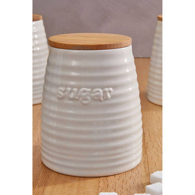 White ceramic cream dolomite sugar canister with natural wood lid and horizontal ridges for kitchen storage