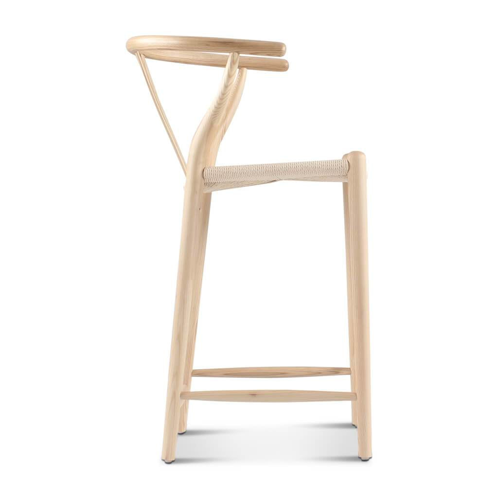 Light-colored wooden wishbone bar stool with y-shaped backrest and woven seat in walnut finish