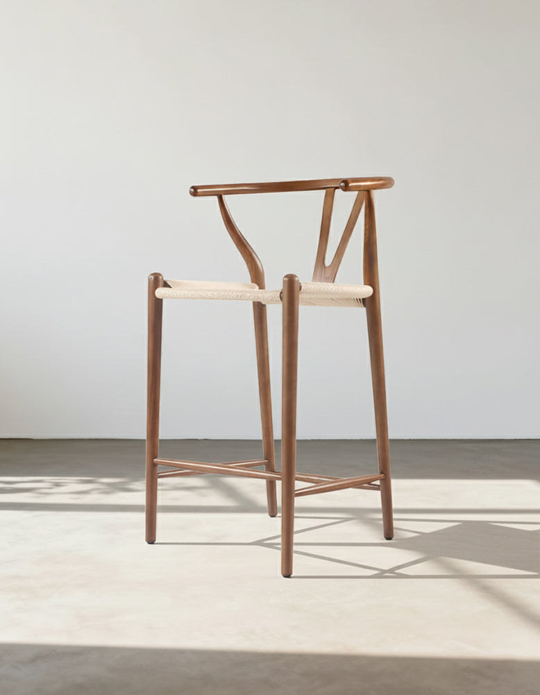 Minimalist wishbone bar stool with y shaped backrest and woven seat in warm walnut wood finish