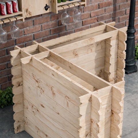 Light-colored wooden interlock corner bar made from rustic unfinished planks with notched edges rustic character tools required