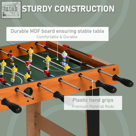 Wooden football table with green surface black hand grips and yellow red players for game room bar use