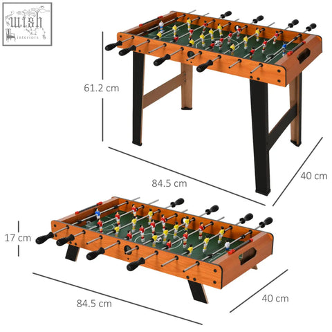 Wooden football table with black legs and green field featuring red yellow blue and white players for game rooms