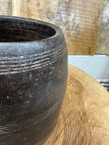 Dark rustic ceramic herb plant pot with subtle ridges and weathered surface for wooden vintage desk tidy use