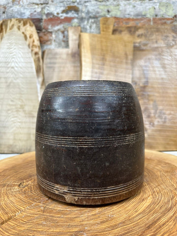 Dark brown wooden vintage herb plant pot with engraved horizontal lines used as a planter or desk tidy