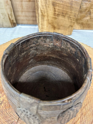 Weathered dark brown wooden vintage herb plant pot with carved patterns and a chipped rim for desk tidy or cutlery holder